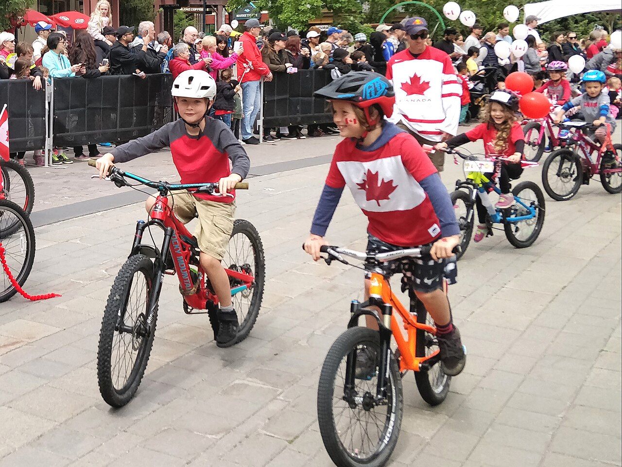 Kids riding bikes in a Canada Day parade